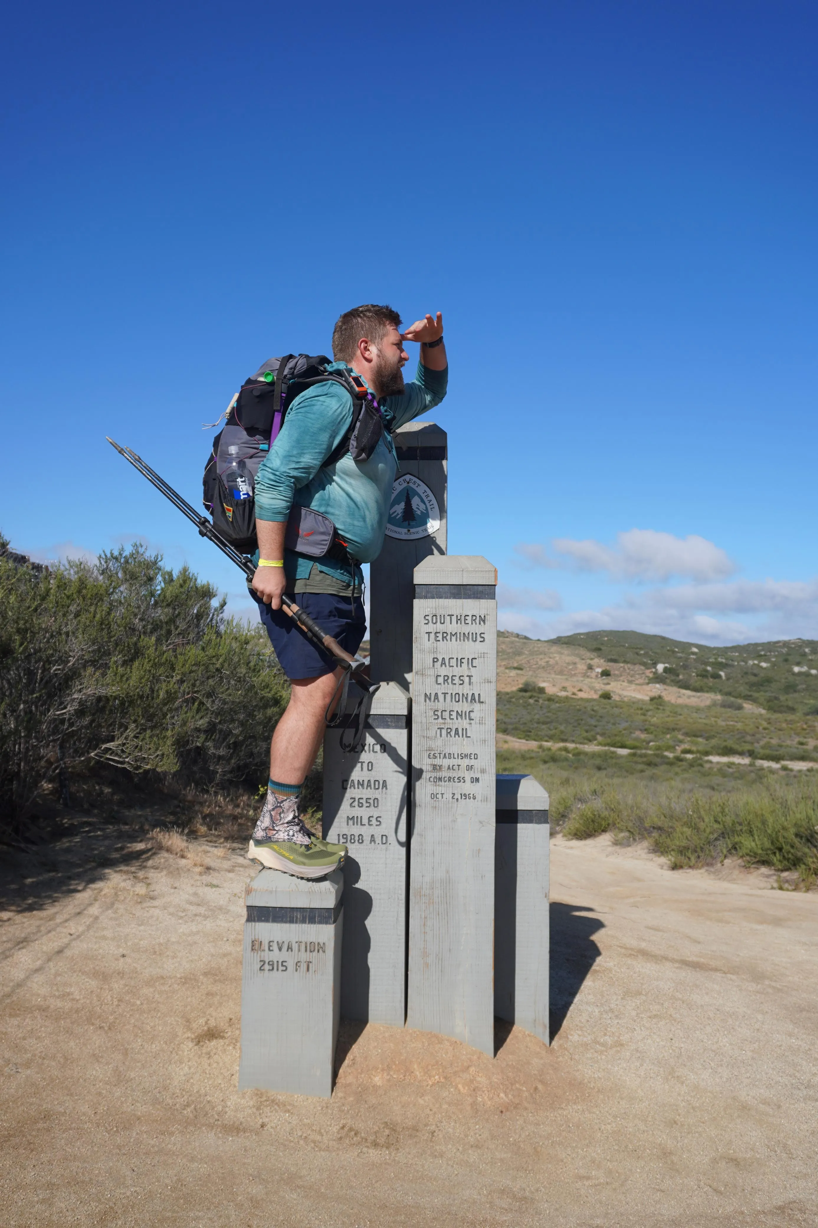 Neil at the Southern Terminus monument on the Mexican border, shading his eyes and looking north